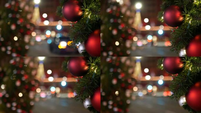 节日装饰的户外圣诞树的特写镜头，模糊的闪闪发光的童话背景上有鲜红色的球。散焦花环灯，波克效应。散焦的