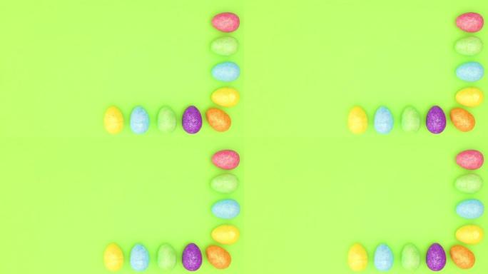 复活节彩蛋出现在绿色背景的右侧和底部-停止运动