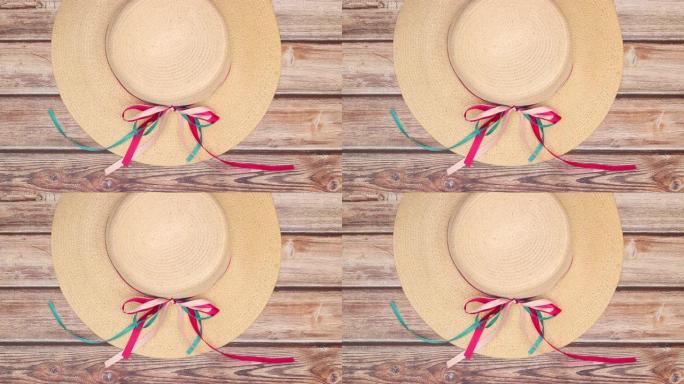 时尚、时尚的女性夏季帽子，带丝带在木制背景上移动 -- 停止运动