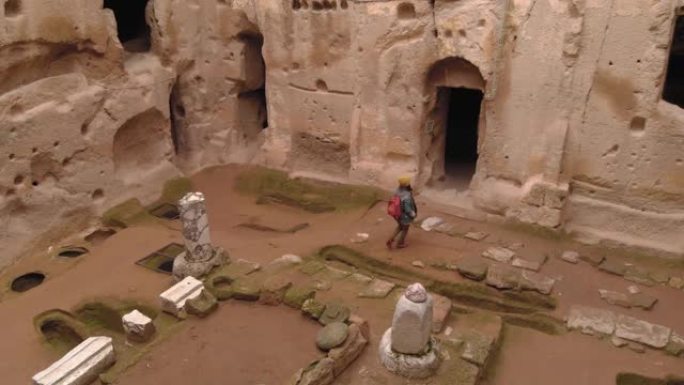 女人独自在卡帕多西亚的古穆斯勒洞穴修道院行走
