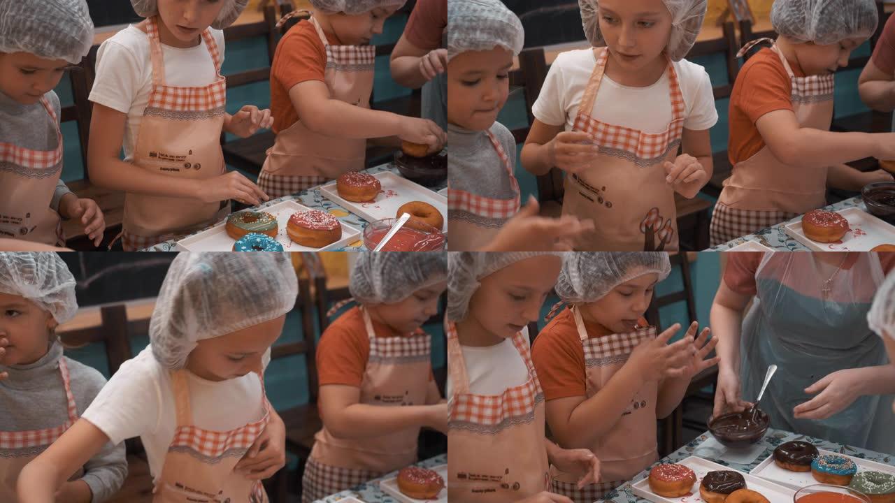 在烹饪学校的烹饪大师课上，孩子们把甜甜圈放在首位。青少年在面包店大师班用彩色釉烹饪甜甜圈。学校的烹饪
