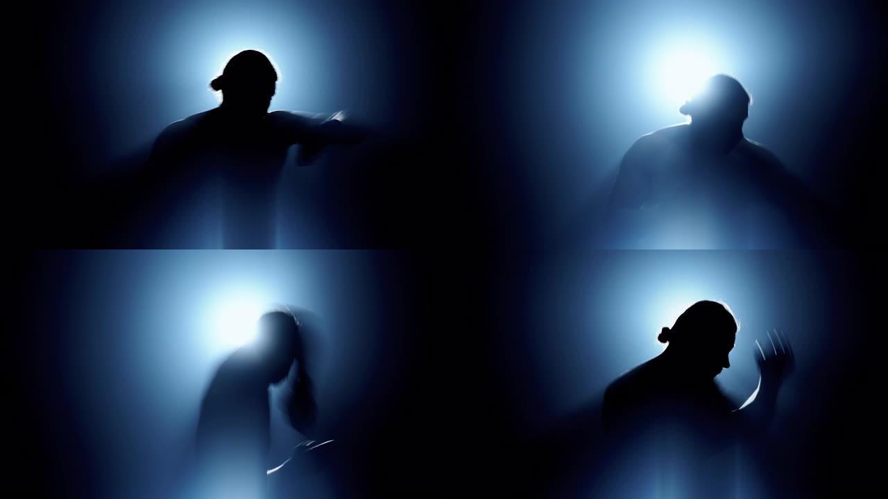 做影泰拳的人的剪影背后有光，侧面有雾和漏光效果。高加索男性。中枪。