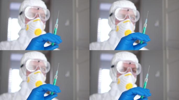 医学研究，冠状病毒疫苗。一名穿着防护服，戴着口罩和呼吸器的男子为患有冠状病毒的患者准备注射