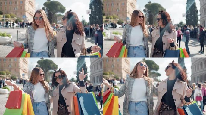 两名穿着奢华时尚服装的女性购物狂拿着五颜六色的纸购物袋走在街上，戴着墨镜的时尚女孩说话、大笑和享受一