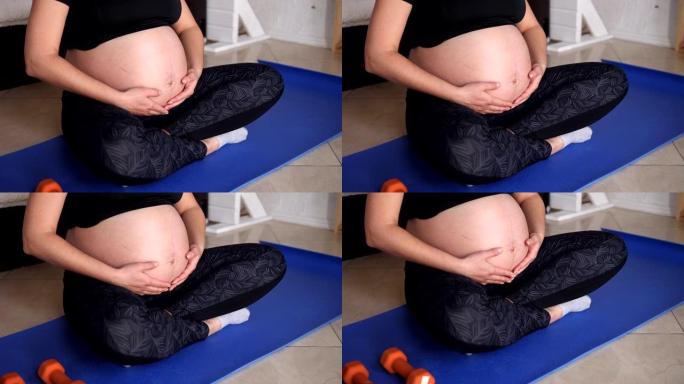 Close-up of pregnant woman doing sports at home, s