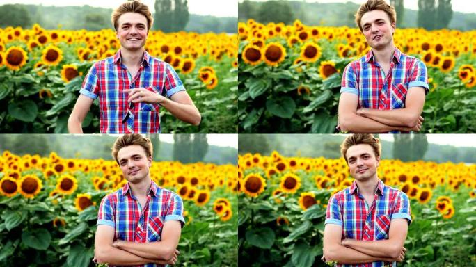 酷炫时尚的年轻男农夫摘下墨镜，成功站立，在向日葵的背景田上