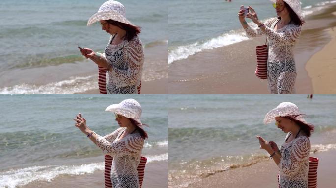 迷人的女人正在拍摄爱奥尼亚海的照片