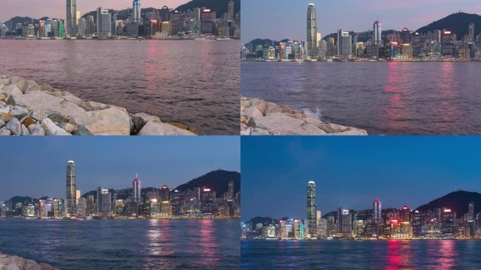 延时夜光和多云的香港天际线，香港城市景观维多利亚港上空的摩天大楼，中国香港