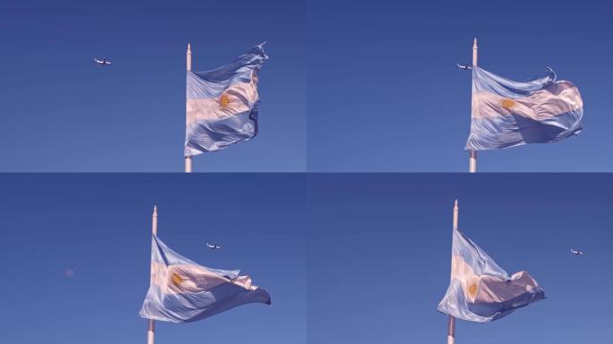 阿根廷国旗在蓝天中挥舞，飞机在背景4 k 50fps镜头中飞行