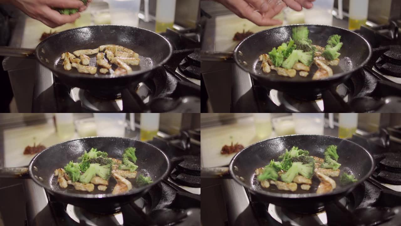在厨房用新鲜西兰花制备切碎的火鸡肉