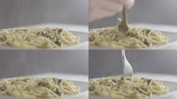在工作室里，一个意大利女人的手以正确的方式用西兰花和橄榄油卷素食意大利面的特写镜头-4k slog3
