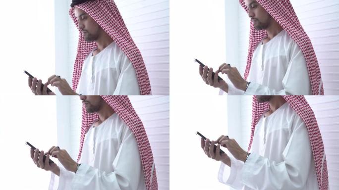 俯仰射击阿拉伯商人使用手机
