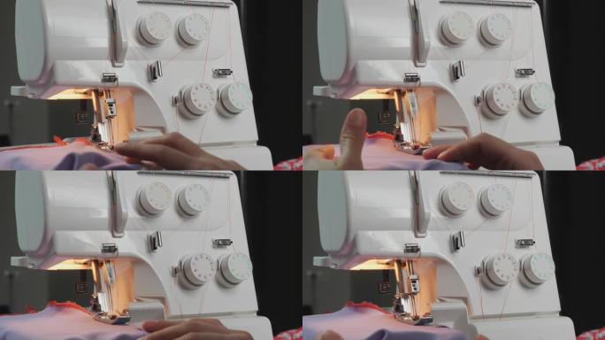 女设计师在缝纫机上工作。女人的手缝制时尚衣服，特写。创造和剪裁服装。overlock机器的详细信息