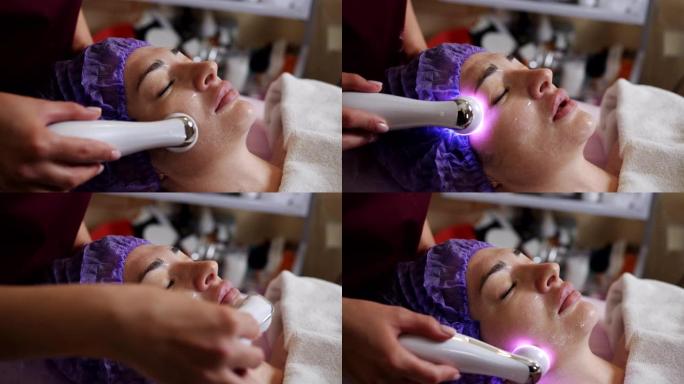 美容师用微晶换肤装置对躺在水疗中心的年轻女子进行面部去角质