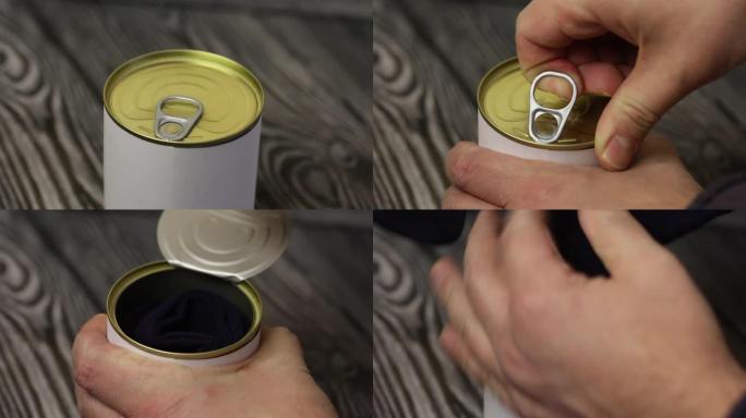 男士袜子装礼品锡罐。一个人打开一个罐子，从里面拿出袜子。特写镜头。