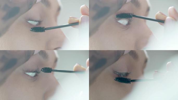 美容师将睫毛膏涂在模特睫毛上的特写镜头
