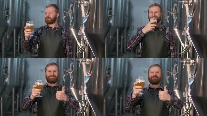 一位成功的商人啤酒酿造商的肖像，留着胡须，站在精酿啤酒生产室时，展示了从啤酒罐中玻璃杯中新鲜酿造的啤