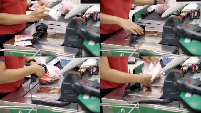 店员在超市商店扫描条形码产品。