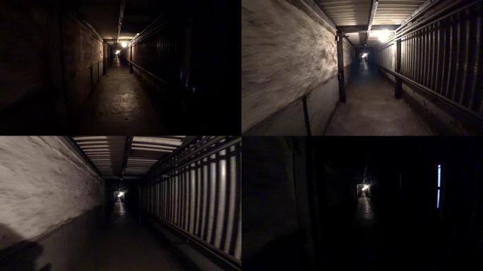 工人走过冶金厂的黑暗走廊。视点，动作相机拍摄。