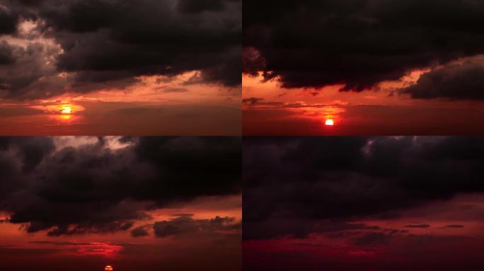 橙色的大太阳的时间流逝，落在红色天空的地平线上，灰色的乌云密布。4k镜头。