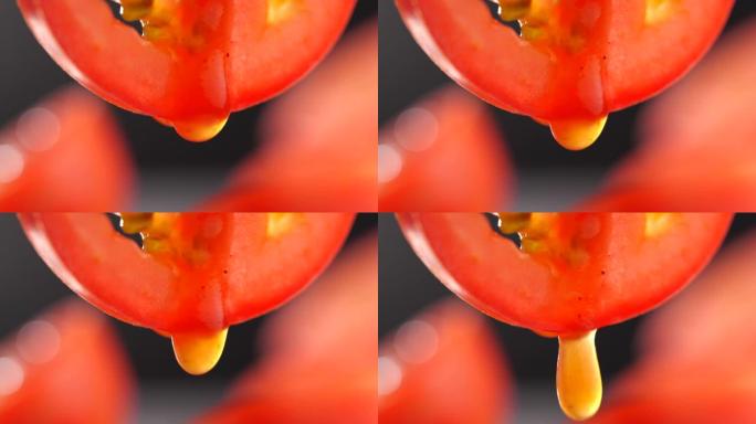 慢动作从番茄片中掉落的番茄酱，用于饮食和健康食品的特写番茄汁
