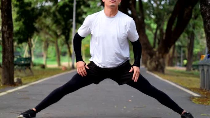 跑步男子在公园跑步，锻炼户外健身。女性慢跑者在有树的公园里的道路和街道上奔跑。跑步者进行户外有氧运动