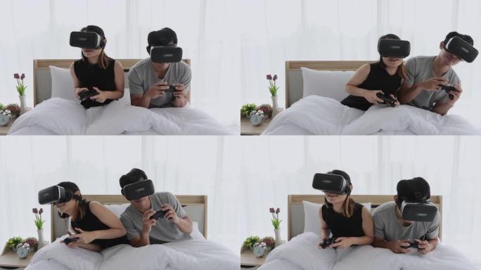 亚洲情侣情人喜欢在卧室玩视频游戏，亚洲情侣情人感觉快乐的乐趣和虚拟现实，虚拟现实一起躺在家里的卧室里