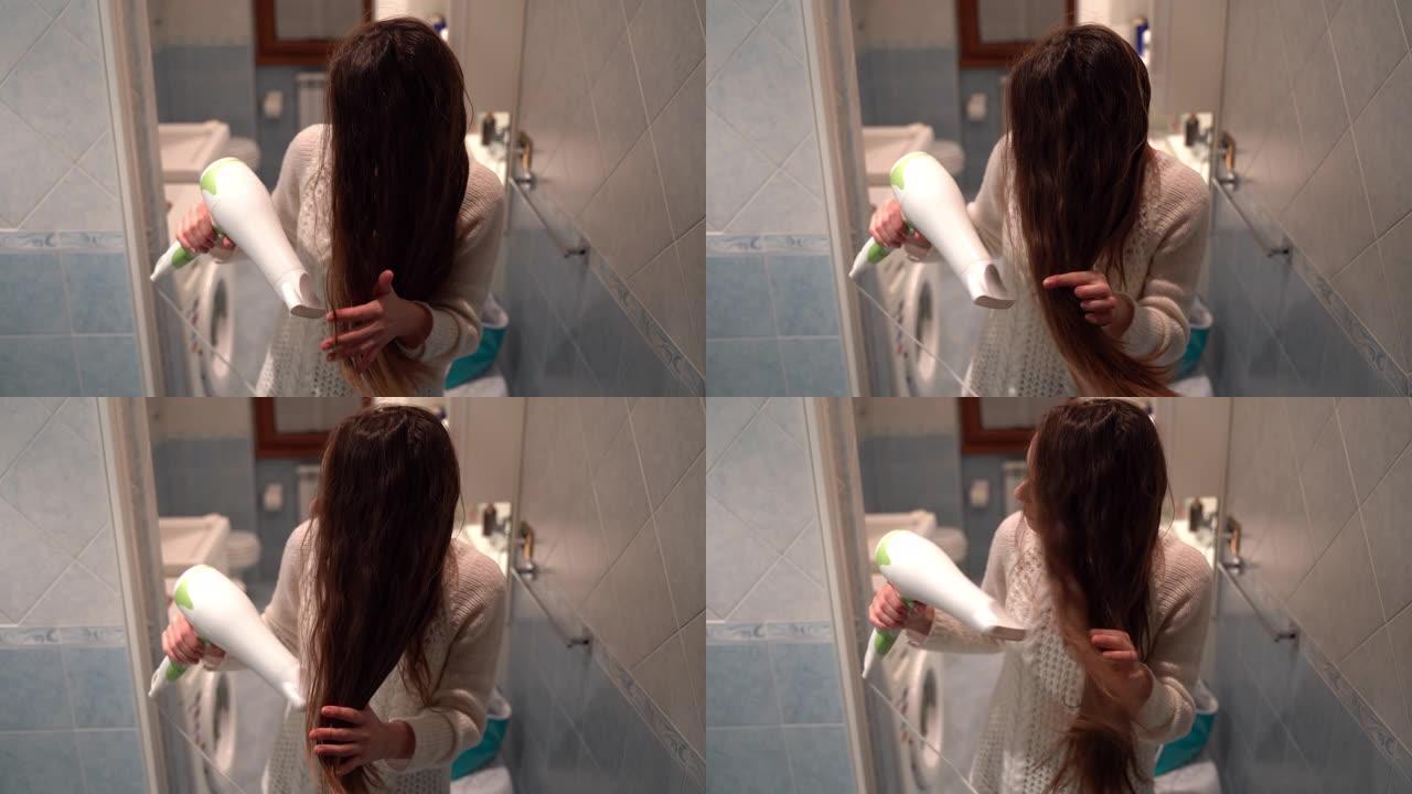 浴室里的头发程序，漂亮女孩淋浴后用吹风机吹干棕色长发。卫生和身体治疗