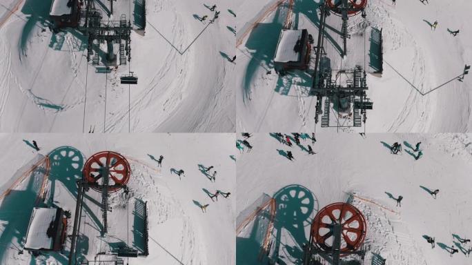 雪坡上交通滑雪者滑雪缆车的空中俯视图。无人机飞越升降椅