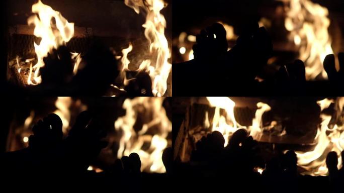 赤裸的双脚在火旁的剪影特写。