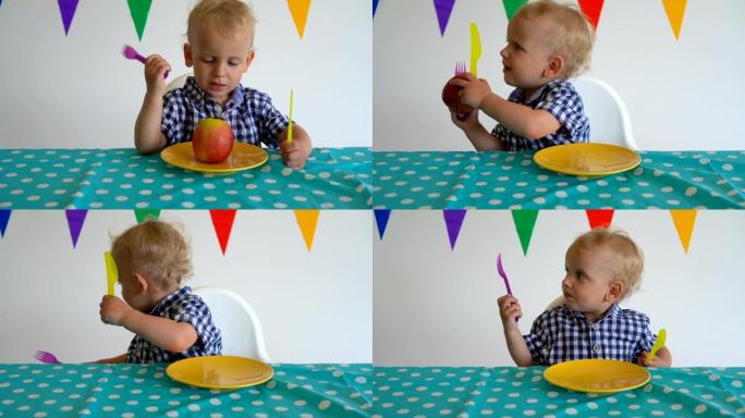 任性的男婴把盘子里的苹果扔了。万向节运动