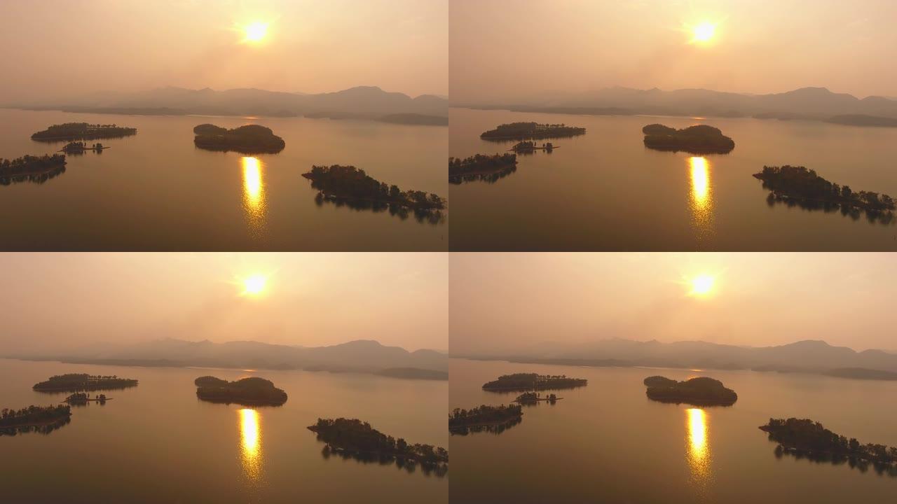 日落时湖中热带岛屿的鸟瞰图