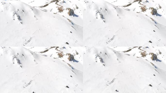 冬季高山登山队在高海拔山峰中连续行走的空中无人机镜头
