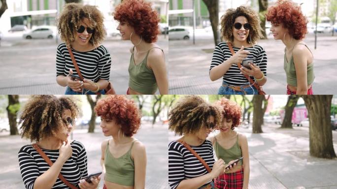 两个西班牙裔朋友在街上分享入耳式耳机和听音乐