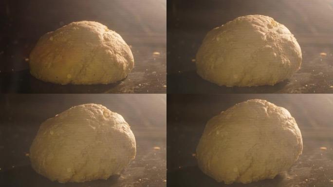 在厨房的烤箱中烘烤有机新鲜面包的特写镜头。面包店里美味面包的延时