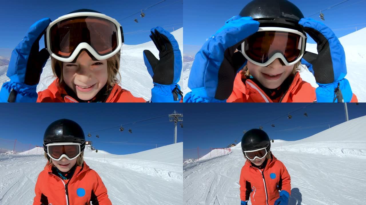 微笑的孩子在雪山上滑雪和挥手