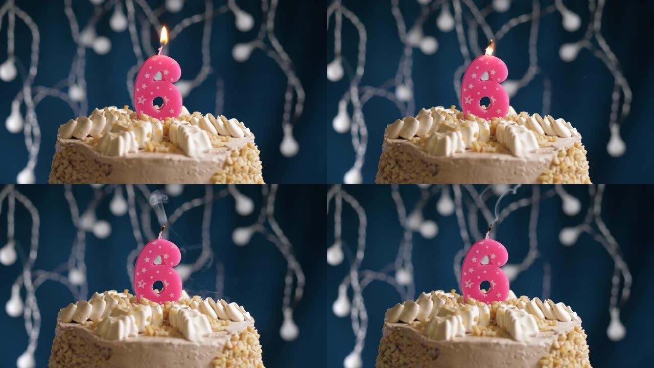 蓝色背景上有6个数字粉色蜡烛的生日蛋糕。蜡烛吹灭了。慢动作和特写视图