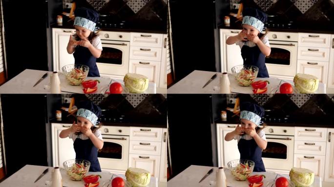三岁的小女孩在厨房玩耍，她用手吃沙拉
