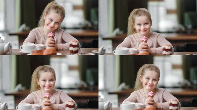小女孩在咖啡馆和冰激凌短号合影的肖像。4k红色相机上的中特写镜头