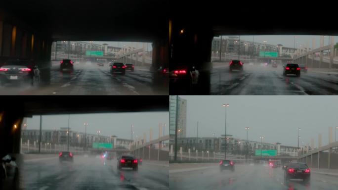 当车辆在高速公路上行驶时，雨刷行驶，远处的警笛声响起，挡风玻璃被雨滴覆盖。