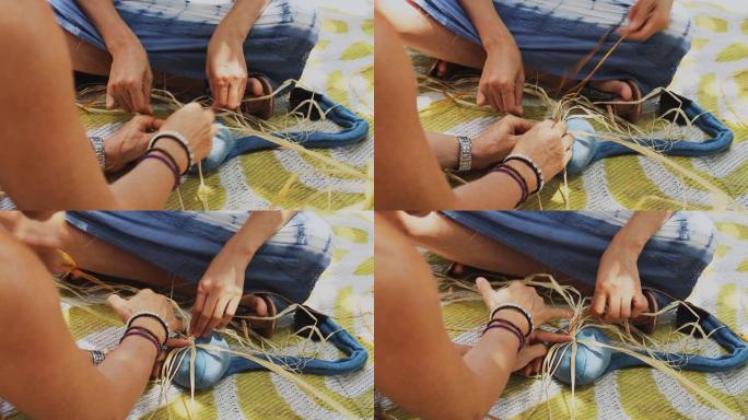 两名高加索女性一起在工艺车间编织篮子。女性双手制作工艺品的特写视频。
