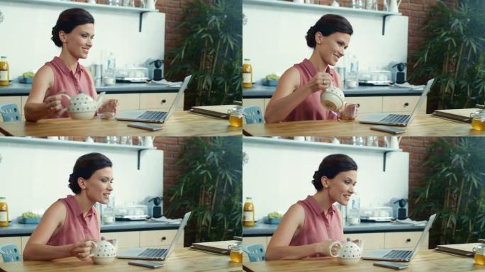 女人在视频通话时把茶倒进杯子里。女孩使用笔记本电脑进行视频聊天。
