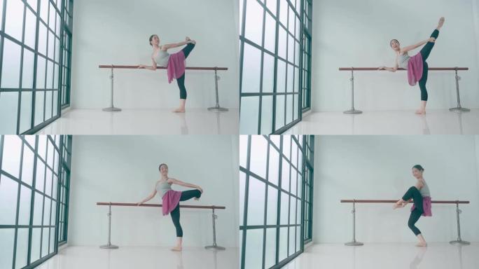 泰国芭蕾舞演员在教室里伸展。经过长时间的训练，她正在做最后的练习。
