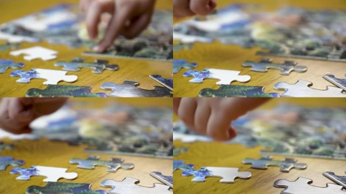 一个五岁女孩在餐桌上收集儿童拼图的特写镜头