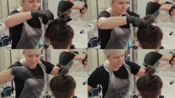 专业美发师女人用铝箔染发剂染发女孩的头发