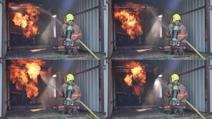 消防员穿防火服的后视图坐在消防训练室里，在消防站慢动作喷水。消防员生涯，训练消防演练理念。