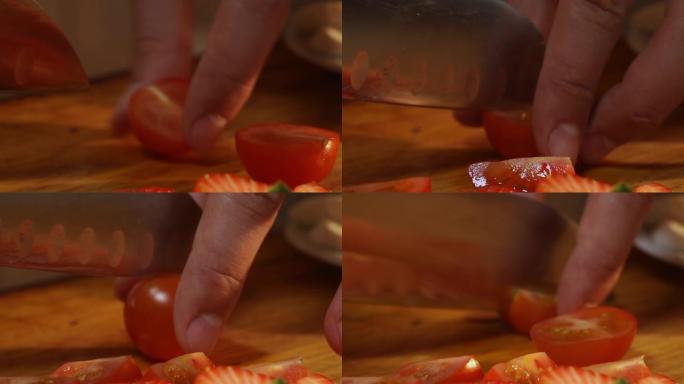 用刀将樱桃番茄切成四分之一的过程特写。