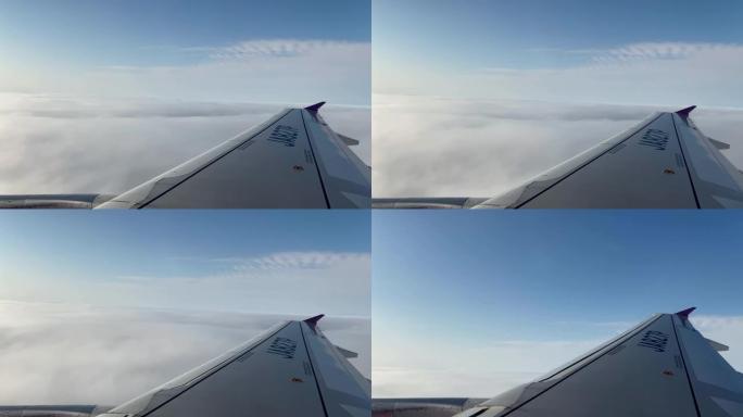 4K，从上方看美丽的云彩，从飞机窗口看。飞机机翼