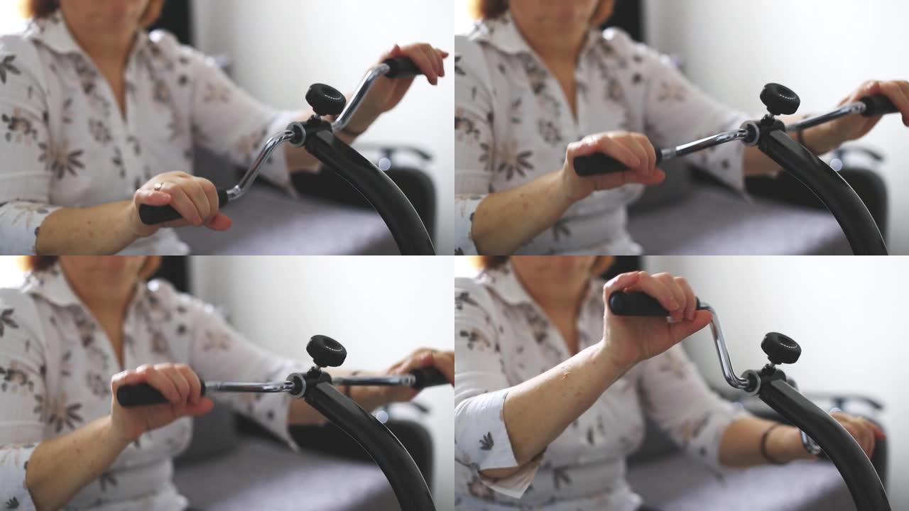 老年妇女在医疗设备上进行手腕的家庭锻炼，理疗