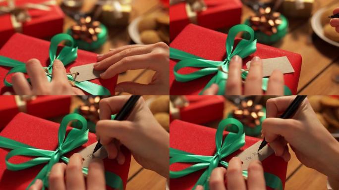 手在圣诞礼物上贴上姓名标签